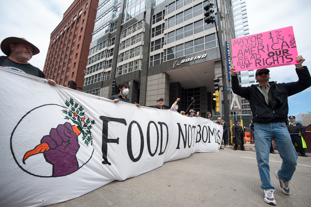 Peaceful protesters marched through the streets of Chicago toward Boeing's headquarters in opposition of the company's contracts to supply the U.S. military with aircrafts and missiles. (Photo by Norbert Schiller/Mint Press)