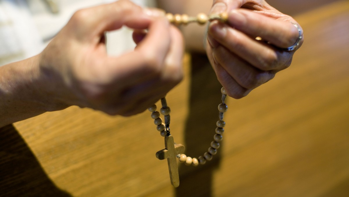 A member of the St. Thomas Korean Catholic Center preys the rosary in their newly built church in Anaheim, Calif., Monday, Aug. 10, 2009. (AP Photo/Philip Scott Andrews)