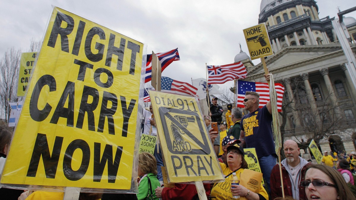 In this March 7, 2012 file photo, gun owners and supporters participate in an Illinois Gun Owners Lobby Day rally at the Illinois State Capitol in Springfield. (AP Photo/Seth Perlman, File)