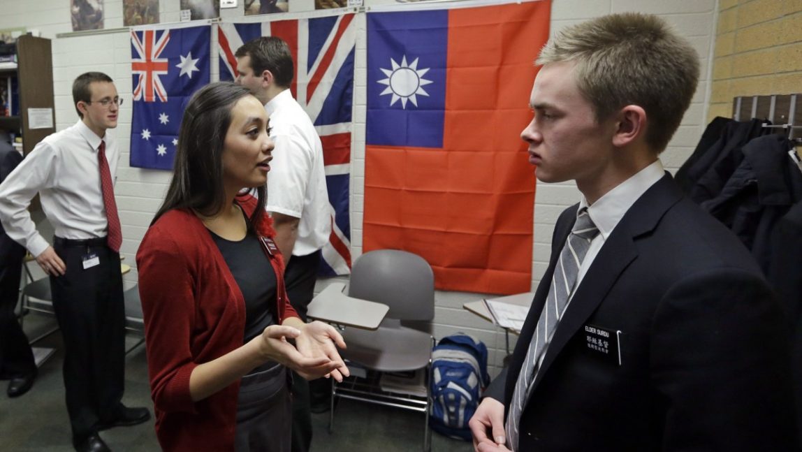 In this Jan. 8, 2013, photo, Mormon missionaries Mikaela Merrill, 19, center, and Harrison Surdu, right, practice their Mandarin Chinese during class at the Missionary Training Center in Provo, Utah. (AP Photo/Rick Bowmer)