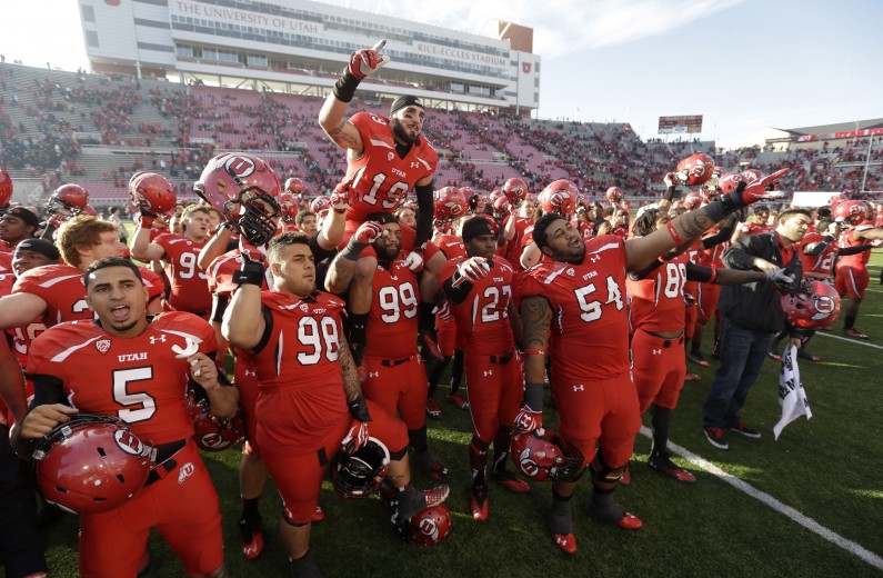 FILE - In this Nov. 30, 2013, file photo, Utah players celebrate at the end of their NCAA college football game against Colorado, in Salt Lake City. University of Utah President David Pershing says he agrees it's time to consider some changes to the school fight song that some find sexist. Pershing announced Monday, May 5, 2014,  he's asking the Office of Student Affairs to oversee a committee that will weigh a "modest update" in the song, "Utah Man." (AP Photo/Rick Bowmer, File)