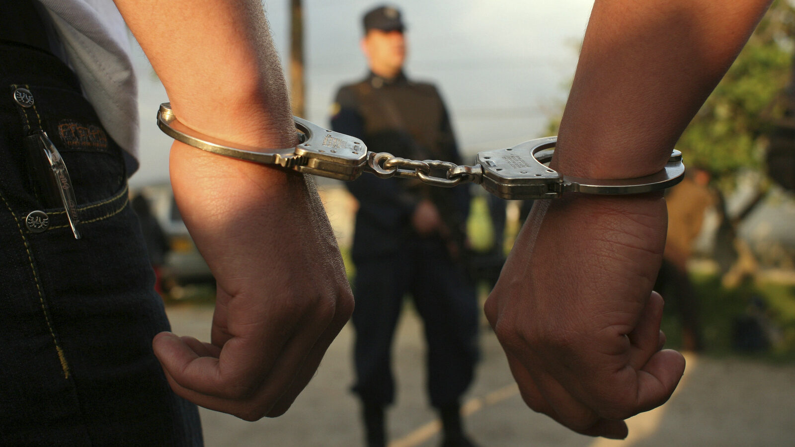 In this March 11, 2009 file photo, two handcuffed rebels of the Revolutionary Armed Forces of Colombia, FARC, walk back to their cells after attending a ceremony where they were graduated as "peacemakers" after they renounced the rebel group and the armed struggle, at La Picota prison in southern Bogota, Colombia. Behind bars some 4,000 FARC members are waiting anxiously for January 2017, for the passage of an amnesty law that will allow them to leave behind long prison sentence and rejoin their comrades as part of a peace deal. (AP Photo/William Fernando Martinez, File)