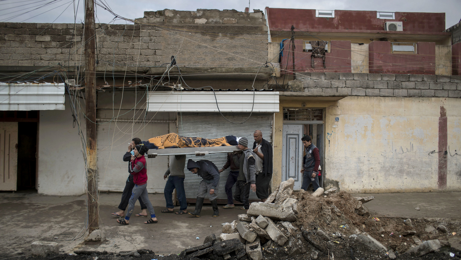 Relatives and friends carry the body of Suheyil Najn Abdullah after he was killed while trying to flee fighting between Iraqi coalition forces and ISIS militants on the western side of Mosul, Iraq, Thursday, March 23, 2017. (AP/Felipe Dana)