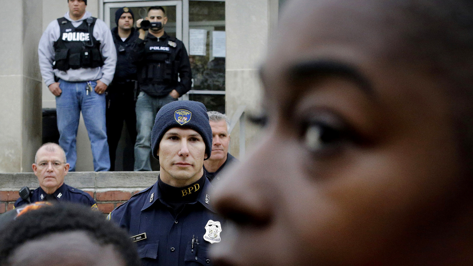 Members of the Baltimore Police Department stand guard outside the department's Western District police station during a protest in response to Freddie Gray's death in Baltimore. Baltimore's mayor and commissioner say they are eager and ready to change not only the culture of law enforcement, but the practice. (AP/Patrick Semansky)