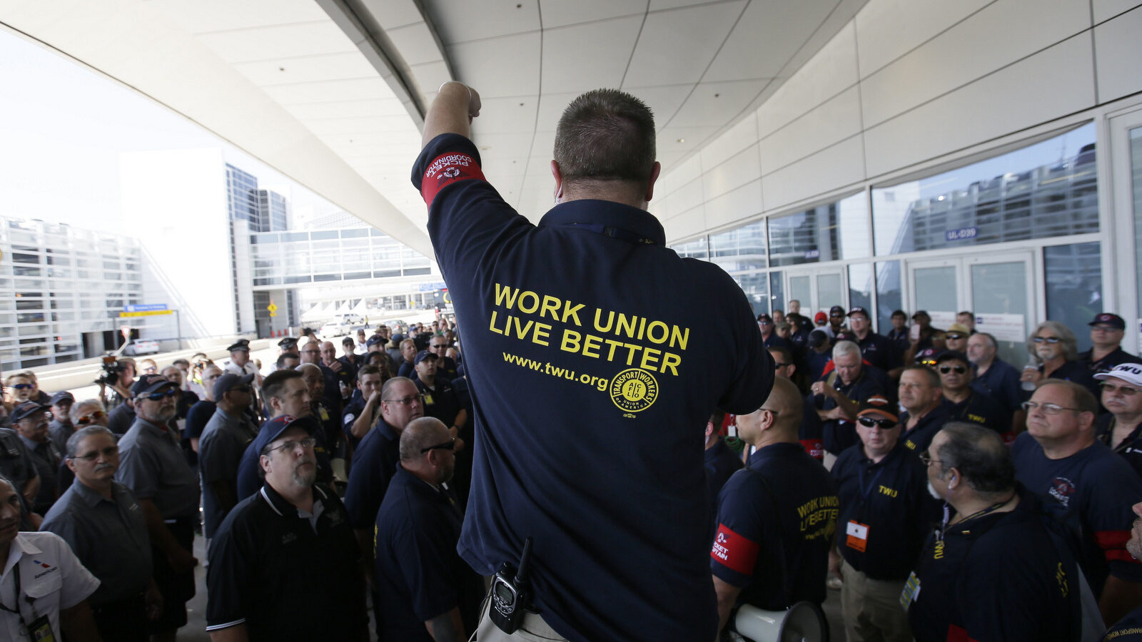 Brian Parker, strategic action coordinator for the Transport Workers Union, addresses a crowd before a protest march at Dallas/Fort Worth International Airport in Grapevine, Texas, July 26, 2017. Protesters from a coalition of different unions participated in a picket against American Airlines and its ongoing contract negotiations with ground workers. (AP/LM Otero)