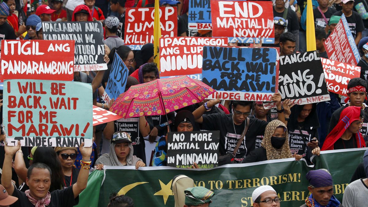 Protesters display placards during a rally near the Presidential Palace calling for an end to the killings in the so-called war on drugs of Duterte and his alleged "tyrannical rule" in the country Thursday, Sept. 21, 2017 in Manila, Philippines. The protest, which coincided with the country marking the 45th anniversary of the imposition of Martial Law by the late dictator Ferdinand Marcos, was among several protests across the country and the biggest so far since Duterte assumed power more than a year ago. (AP Photo/Bullit Marquez)